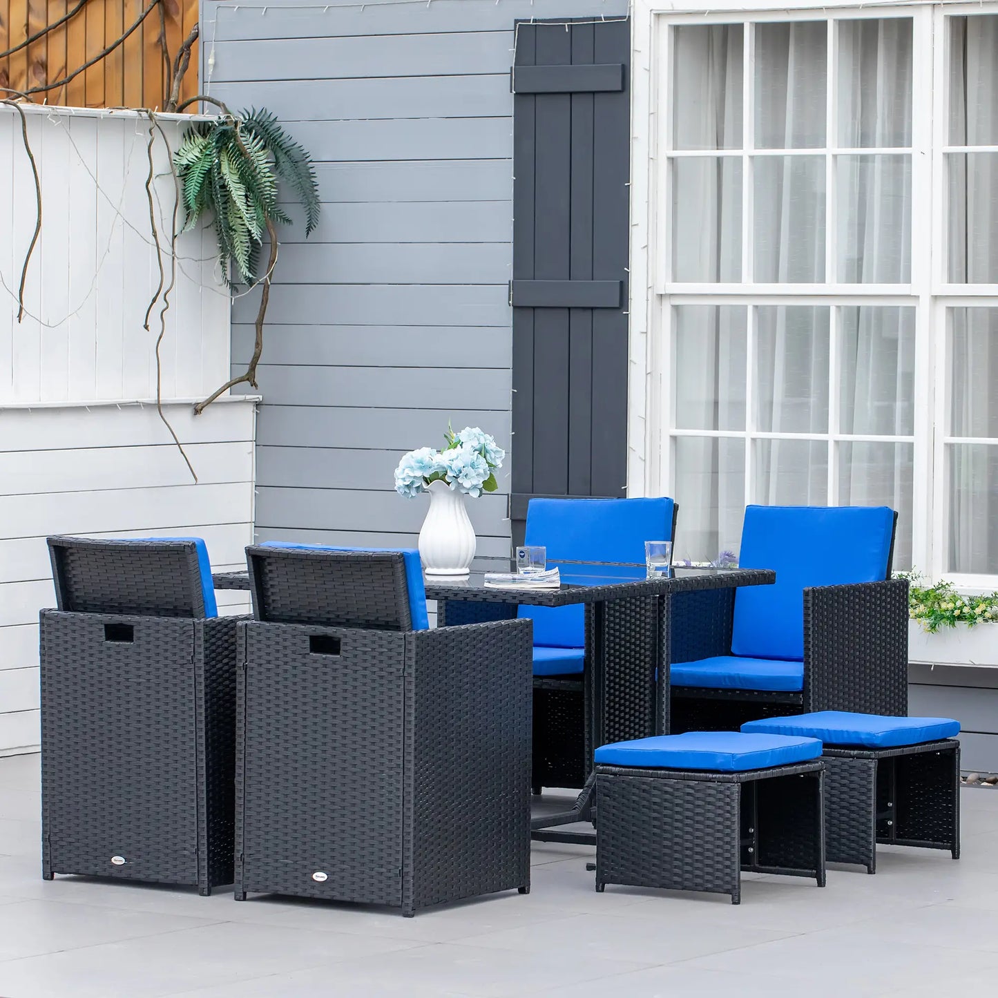 9-Piece Wicker Patio Dining Set, Glass Top Table, Ottomans, Blue Outdoor Dining Sets at Gallery Canada